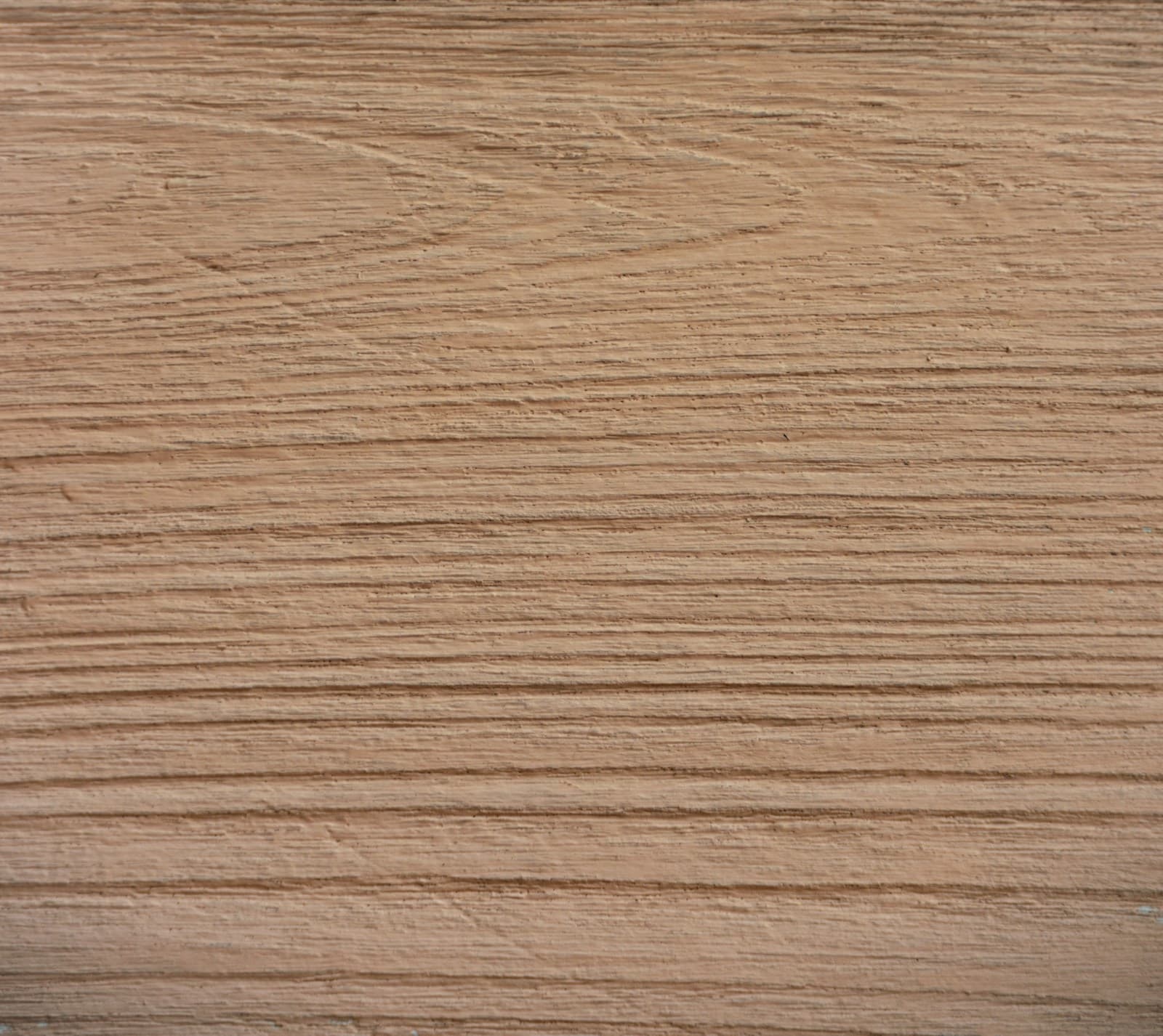Close-up of wood grain with warm light highlighting the texture